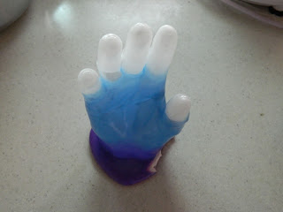 wax impression of hand in violet, blue and white