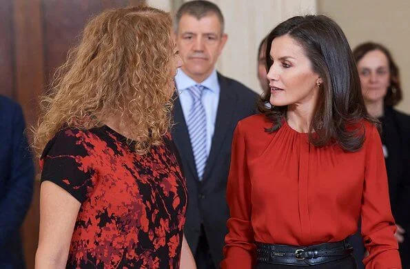 Queen Letizia wore Hugo Boss Banora red gathered neck silk blouse and Carolina Herrera black poppy-print knit skirt, gold diamond earrings