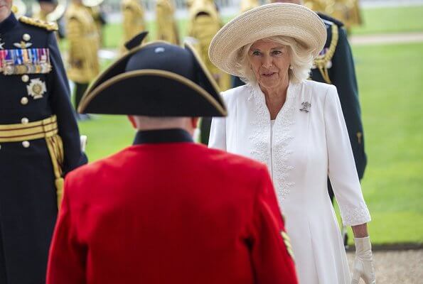The Duchess of Cornwall wore a white embroidered coat dress with beige leather shoes, and beige hat and she carried beige clutch