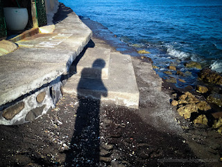 Shadow Of Person On The Edge Of The Beach Barrier By Morning Sunlight At Umeanyar Village North Bali Indonesia