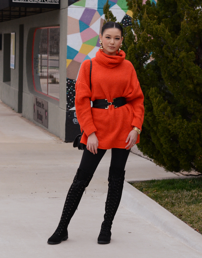 orange turtle neck knit sweater, over the knee lace up boots, waist belt