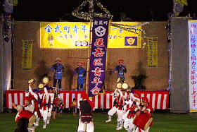 drums, dancers, stage, musicians, village banner