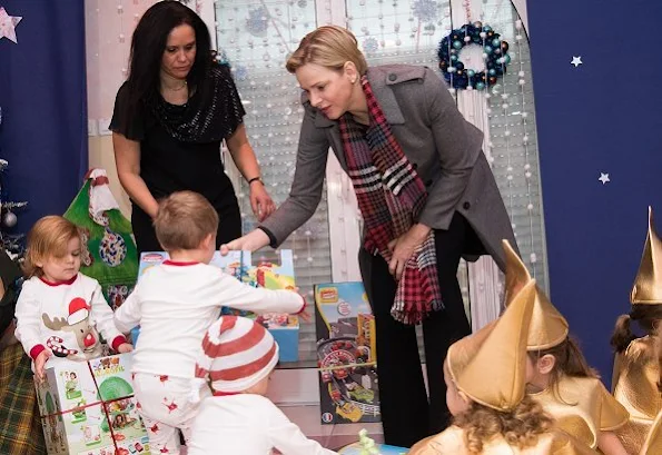 Princess Charlene wore Louis Vuitton wool coat. Rosine Sanmori Nursery / Day Care Centre in Fontvieille. Christmas gifts