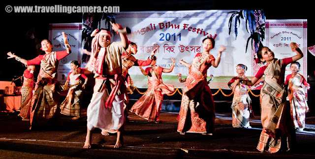 Rogali Bihu Festival 2011 by Assam Association, Delhi @ Indira Gandhi National Center of Arts, New Delhi, INDIA : Posted by VJ SHARMA on www.travellingcamera.com : 'Assam Association, Delhi' celebrated Rongali Bihu Festival on 24th April 2011 at Indira Gandhi National Center of Arts (IGNCA) on Ranjendra Prasaad Road near Central Secretariate Metro Station in Delhi !! This event took place during the lovely evening on Sunday in the presence of a huge audience in traditional getups. The attendance was large by Delhi standards and I am totally fan of Assamese Culture !!! Check out these Photographs from RONGALI BIHU FESTIVAL 2011 ....On Sunday morning I was chatting with one of my friend on Facbook and she told me about this event !! Although it was a lazy Sunday for me but I thought of not missing this opportunity to get out of the house and feel the heat of Delhi :)  I also took two office friends along and had a great evening !! This event continued till 11:00 pm but we had to leave early. That was a sad parfor us, as no one of us wanted to leave the place...Bohag Bihu is the national festival of Assamese as it marks the beginning of the New Year (Nava Varsha !!!). Rituals and customary practices of Bohag Bihu starts from April 13 of year. There are three forms of a Bihu festival namely Bohag Bihu or Rongali Bihu (in the middle of April), Magh Bihu or Bhogali Bihu (middle of January) and Kaati Bihu or Kongali Bihu (in October/ November). To start the program, a group of Assam association came and sang a beautiful song in their local language... It seems that song they sung was very significant and has good impact on Assamese culture !!!Rongali Bihu (Bohag Bihu) is the most important day of all the three Bihu festivals. This day begins with the sowing of seeds, Kaati Bihu marks the complete process of sowing and transplanting of paddies, and the Magh Bihu marks the end of the harvesting period.Here is the lady who managed the stage with another gentleman !!! I really loved the dressup of all the men and women thir... beutiful Saaris and kurtas !! No words to explain the uniqueness and the impressions of strong culture !!!It's just the beginning ! I was hoping some hip-hop :) ... But whole evening was packed with  various versions of Bihu Dance performances... I was asked to wait till the end for actual and the BIG Bihu performance, but I had no option :(The Bihu dance  is a folk dance from the Indian state of Assam related to the festival of Bihu. This joyous dance is performed by both young men and women and is characterized by brisk dance steps and rapid hand movement. Dancers wear traditionally colorful Assamese clothing and this adds more value to overall performance !!! Huchori - Huchori is an integral part of Rongali Bihu. Choral parties of singers and dancers moving from house to house is a salient feature of Rongali Bihu !!!A group of boys performed Hichuri on the stage and it was really interesting to see overall getup of folks in the groups and it seems elder folks also join this group to better guide theyounger ones :) .. Although I was not able to make any sense out of the songs or dialogs, but it looked very interesting !!!The word Bihu is derived from the language of the Dimasa Kacharis... Their supreme god is Brai Shibrai or Father Shibrai. The First crops of the season are offered to Brai Shibrai while wishing for peace and prosperity. So Bi means 