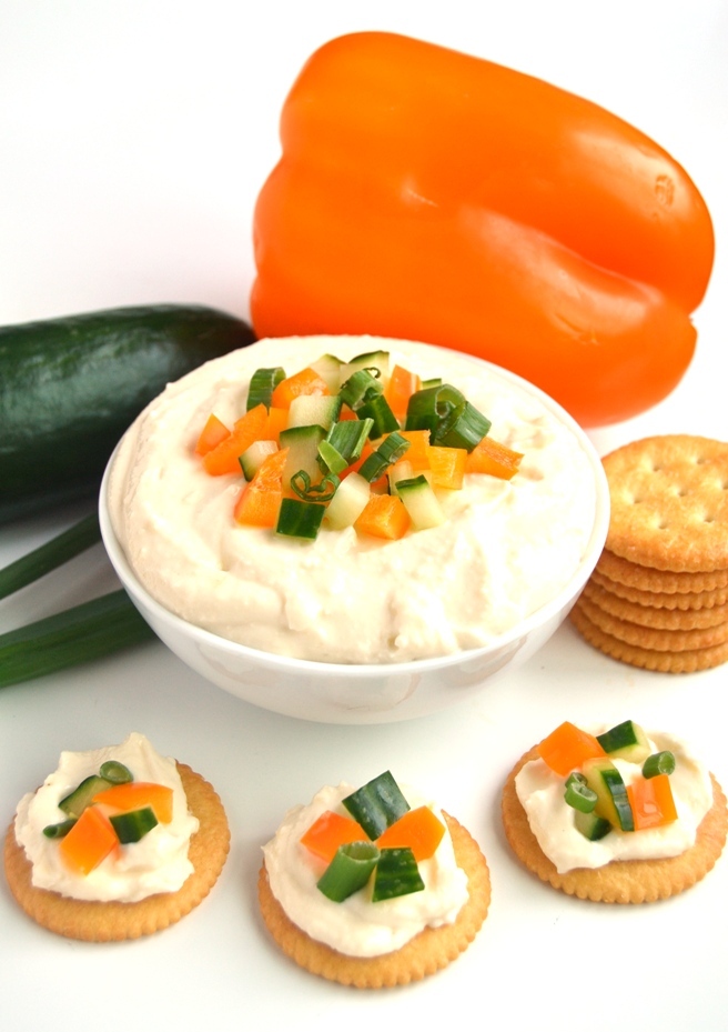 White Cheddar Horseradish Dip is ready in 5 minutes, has just 4 ingredients and is full of flavor with sharp white cheddar cheese and tangy horseradish! Topped with finely diced vegetables and served with crackers for an easy appetizer. www.nutritionistreviews.com