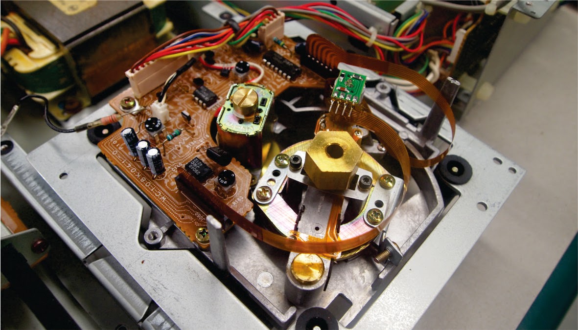 On the bottom side there's a different preamplifier and motor driver board  and a different spindle motor. This CDM1 uses a brushed motor, but it's  Japanese ...