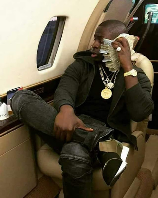  Photos of son of incoming President of Zimbabwe flaunting cash and luxury car on social media