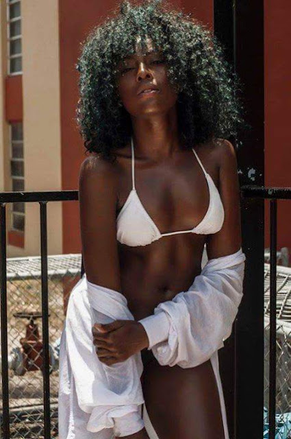 Beautiful melanated dark skin woman with amazing curly Afro.