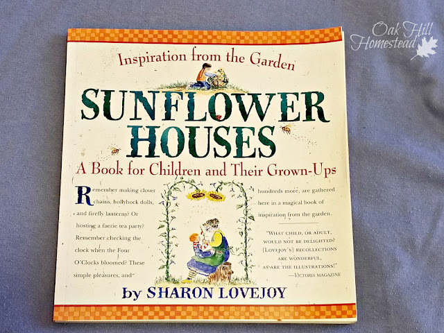A book on a table: Sunflower Houses by Sharon Lovejoy