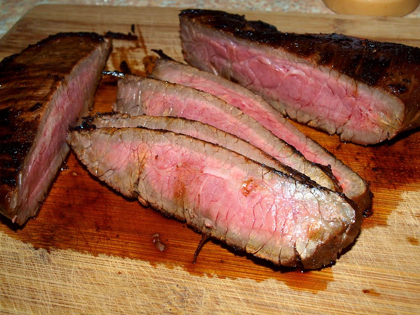 Pellet Smoker Cooking Grilled Flank Steak, veggies and couscous