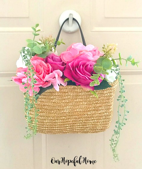 floral rattan tote hanging on door with flowers