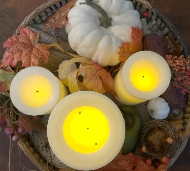 Faux candles and foliage create a one of a kind lasting centerpiece for a round table. www.homeroad.net