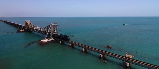 The Pamban Bridge  is a cantilever bridge on the Palk Strait connects Rameswaram on Pamban Island to mainland India. It refers to both the road bridge and the cantilever railway bridge, though primarily it means the latter. It was India's first sea bridge. It is the second longest sea bridge in India (after Bandra-Worli Sea Link) at a length of about 2.3 km. The rail bridge is for the most part, a conventional bridge resting on concrete piers, but has a double leaf bascule section midway, which can be raised to let ships and barges pass through.