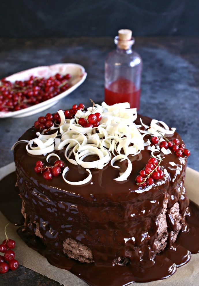 Recipe for a 4 layer chocolate cake with raspberry syrup, chocolate mousse filling and ganache topping.