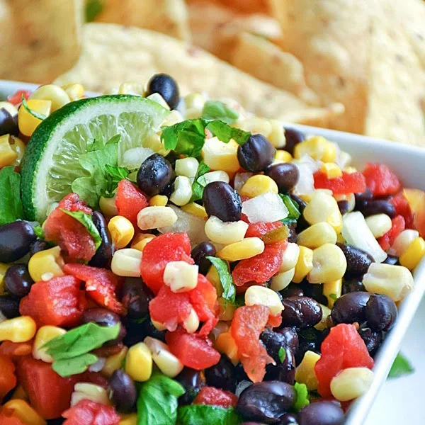 Corn and Black Bean Salsa | by Life Tastes Good is a sweet and spicy combination of corn, black beans, spicy tomatoes, onions, cilantro and lime to create an addictive salsa recipe perfect for any occasion. Appetizer, Salad, Mexican, Party