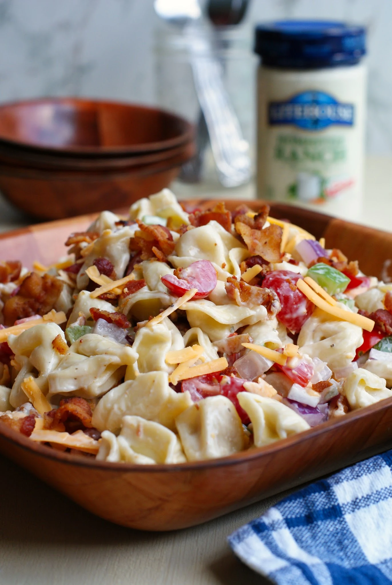 Bacon Ranch Tortellini Salad in a wooden bowl.