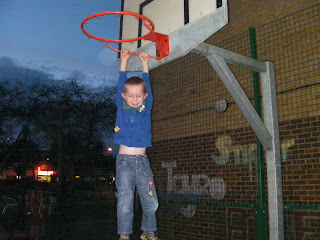 hanging off a basketball hoop