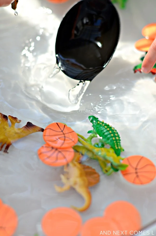Fine motor water sensory play for toddlers and preschoolers using dinosaurs and basketballs from And Next Comes L