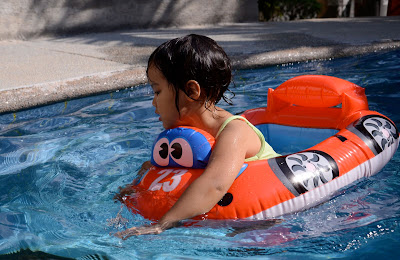 Kecil driving her float in the pool
