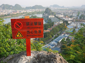 "no climbing" and "warning drop down" sign