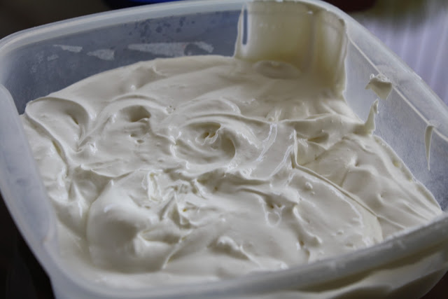 Cream cheese frosting in a plastic container. 