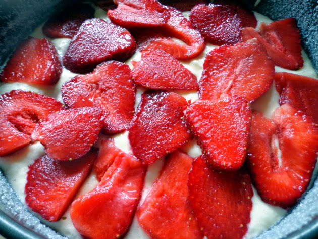 top the batter with sliced strawberries