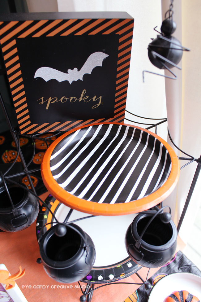 spooky wood sign, spider plate stand, cauldron, paper plates, party