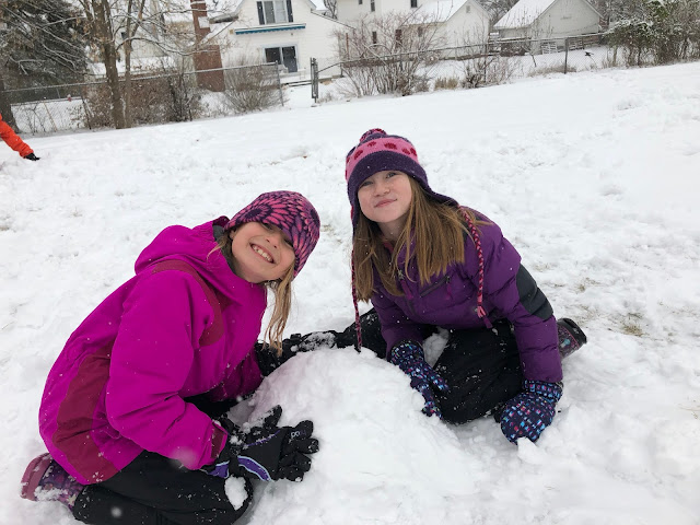 Kids building snow fort