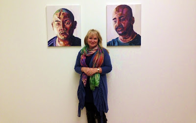 Rev Christie Buckingham with portraits of Andrew Chan and Myuran Sukumaran.