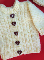 http://www.craftsy.com/pattern/knitting/toy/cardigan-headband-trouser-set-18-in-doll/223068