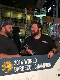 Luke Darnell and Jay Ducote celebrate Luke's $10,000 prize check an title of World Barbecue Champion!