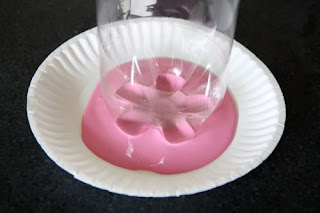Langkah kedua celupkan bagian bawah botol ke cat berwarna pink