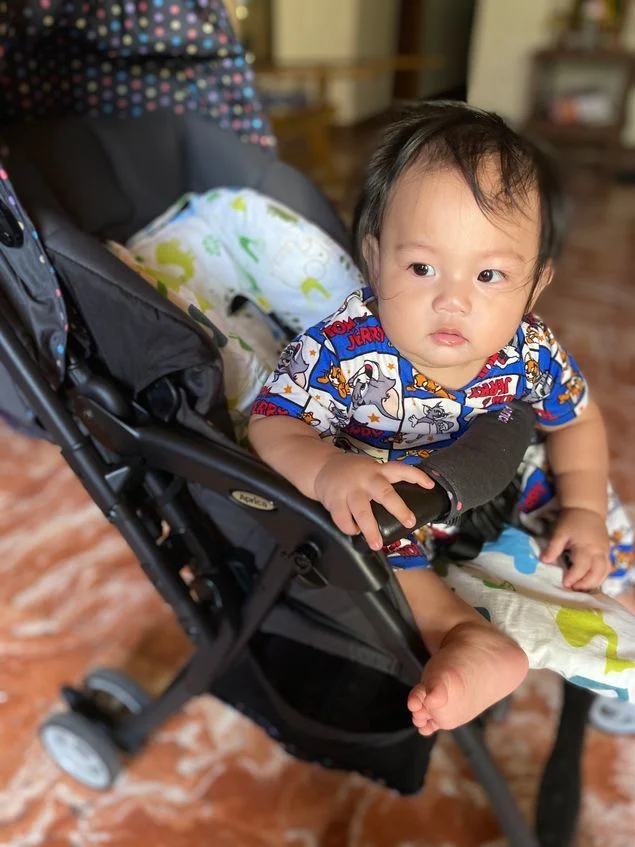 Our little boy comfortably sitting in his Aprica Baby Stroller