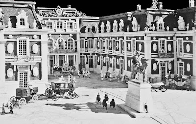 b/w image Versailles 1/48 model basic exterior with vehicles and people.