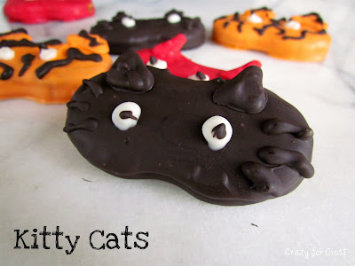 nutter butter cookies decorated to look like cat halloween masks