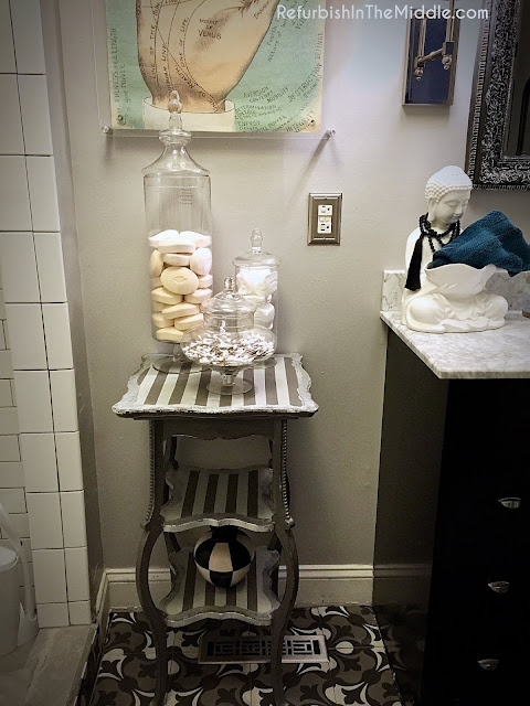 gray and silver striped table painted with chalk paint displayed in a bathroom with decor