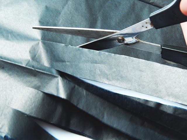 Scissors cutting tissue paper