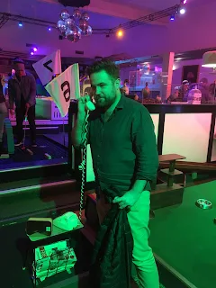 Bren holding a prop telephone at Holey Moley mini golf in Melbourne VIC