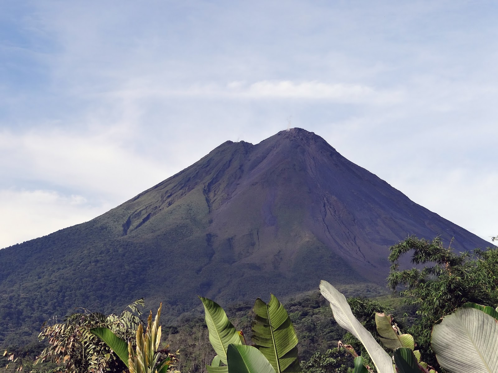 Love Goat Films A rainy hike on the picturesque Arenal Volcano's lava