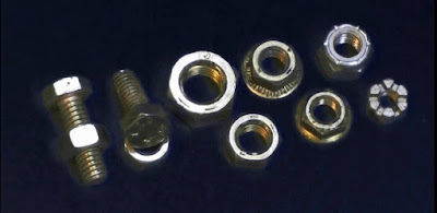 Variety of nuts and bolts on a black background