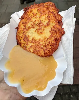 Reibekuchen and applesauce at the Christmas market in Dortmund Germany