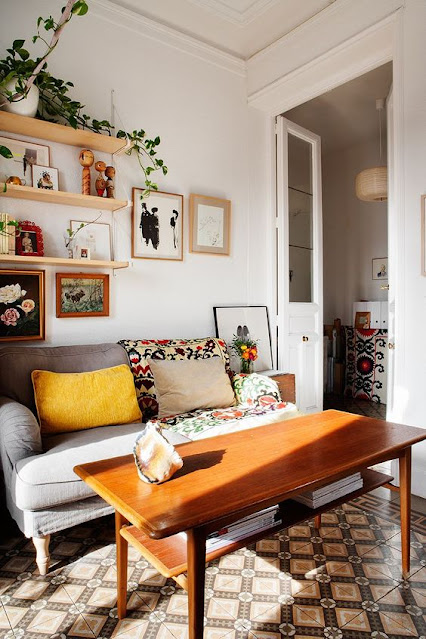 Uma sala de estar com uma planta decorando o alto de uma prateleira trazendo benefícios para a saúde