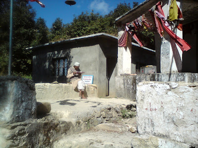 A old man praying to their local deity in the Himalayas in Kemundakhal temple