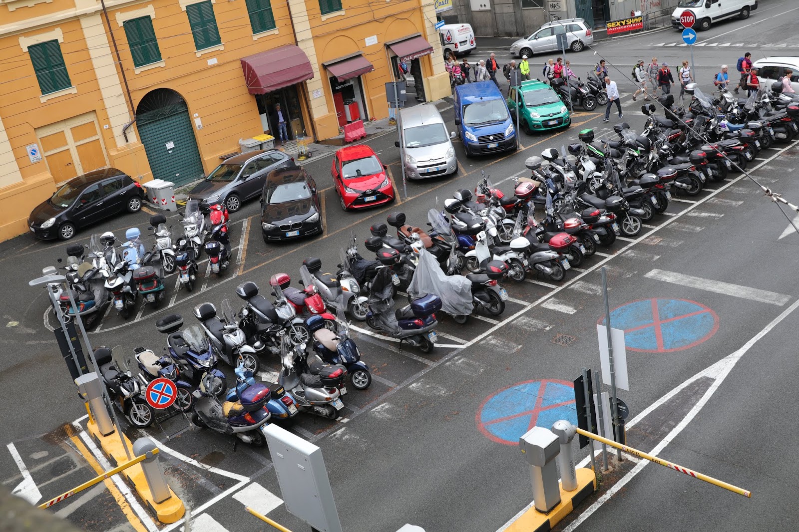 OldMotoDude Motorcycles and Scooters in a parking lot in La Spezia, Italy.