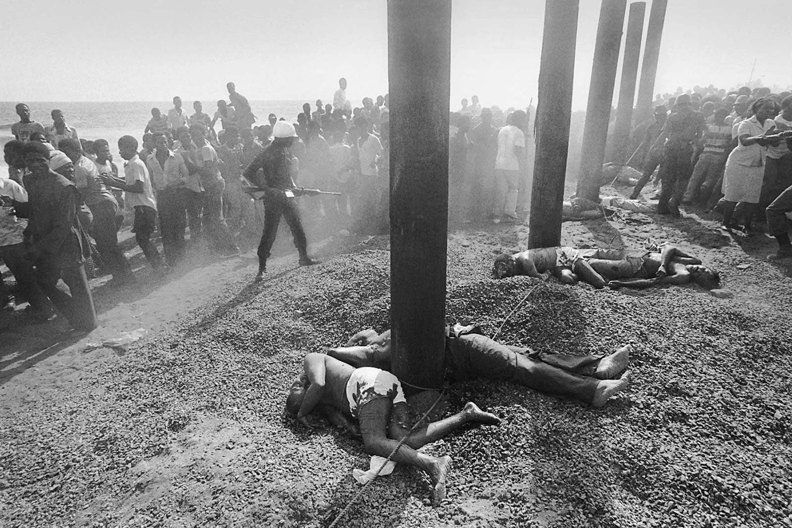 A crowd gathers to view the bodies of 13 former cabinet members.