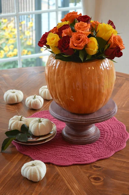 Pumpkin Vase Floral Arrangement on table with white baby pumpkins