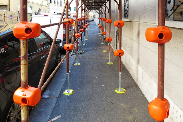 Orange coupler covers on a scaffolding, Livorno