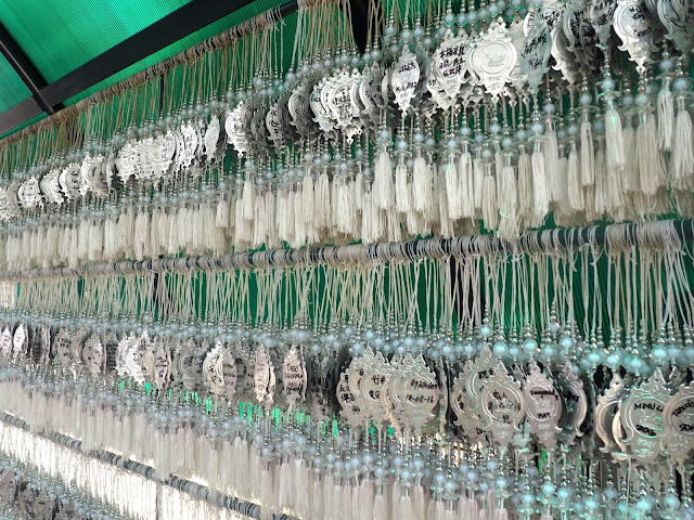 Hanging ornaments with dedications from visitors at the White Temple, Chiang Rai province, north Thailand