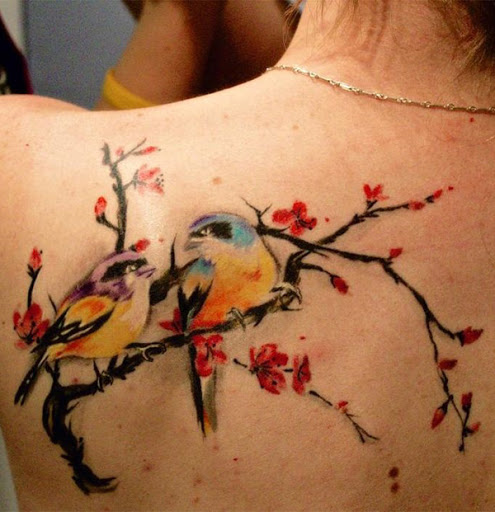Bela flor de cerejeira tatuagem sobre os ombros com as duas aves. As aves dar as flores de cerejeira e até mesmo romântico vibe como eles olham para o outro enquanto silenciosamente passando o tempo no ramo de árvore. (Foto: Fontes de imagem)