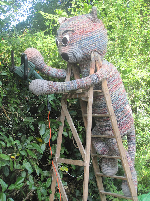 Fiddly Fingers Chester crochet cat hedge trimming up a ladder